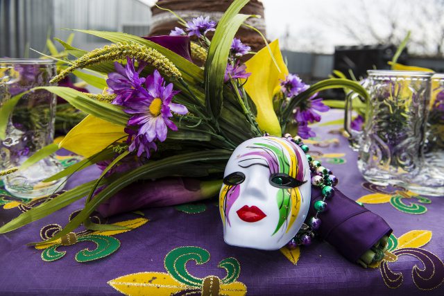 Mardi Gras mask with yellow, purple, and green and purple flowers