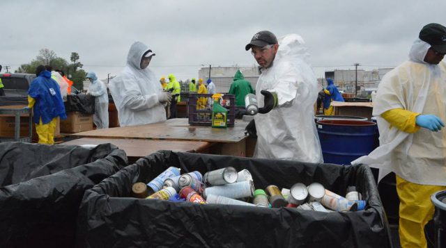 Hazardous Materials: people in white hazmat suits sorting materials