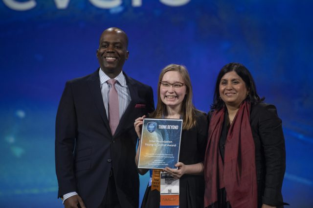 Intel: a young girl recieving an award from two adults